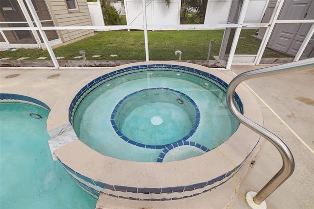 view of swimming pool with a yard and an in ground hot tub