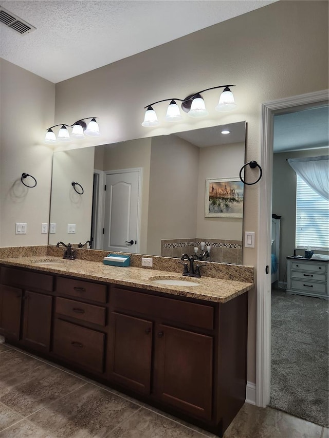 bathroom featuring vanity and a textured ceiling