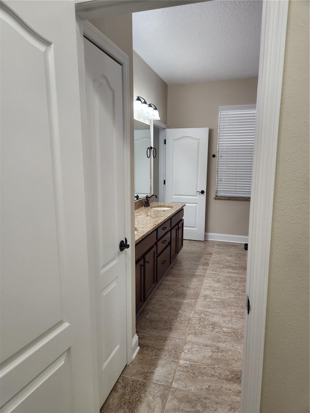 bathroom with vanity and a textured ceiling