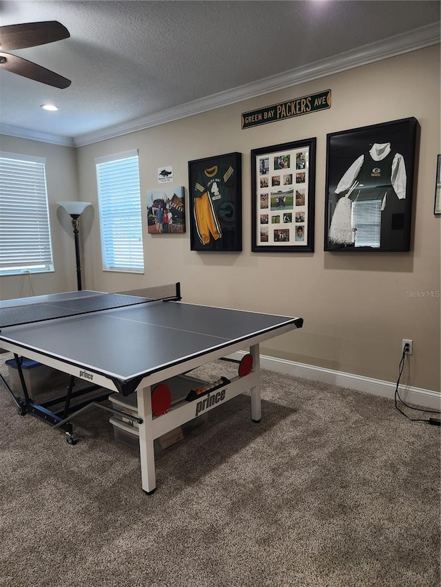 game room featuring carpet floors, a textured ceiling, crown molding, and ceiling fan