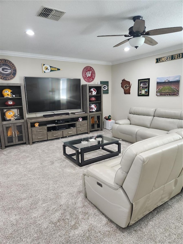 carpeted living room with a textured ceiling, ceiling fan, and crown molding