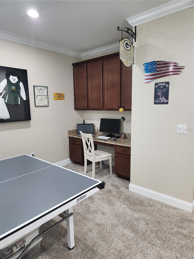 game room with built in desk, light colored carpet, a textured ceiling, and crown molding