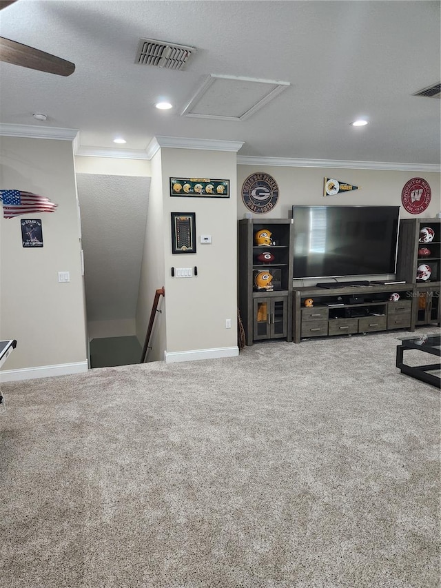 carpeted living room featuring a textured ceiling, crown molding, and ceiling fan