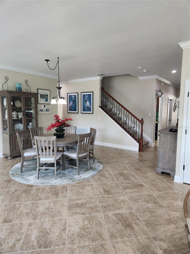 dining space with a textured ceiling and ornamental molding