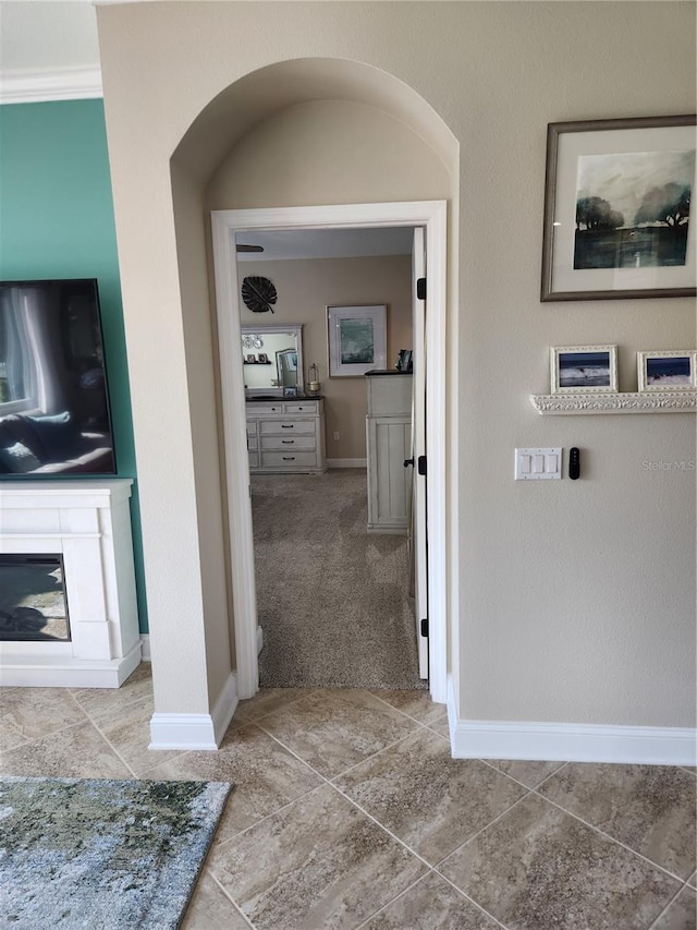 corridor with carpet flooring and crown molding