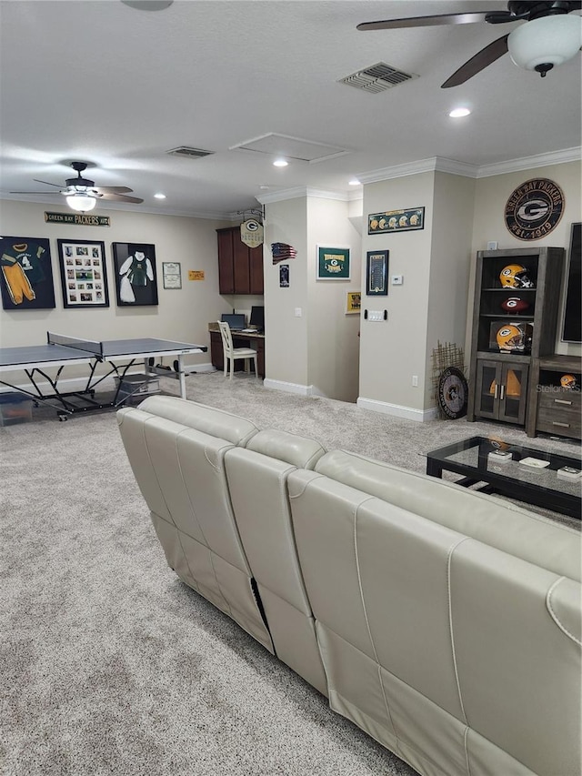 living room featuring carpet, ceiling fan, and crown molding