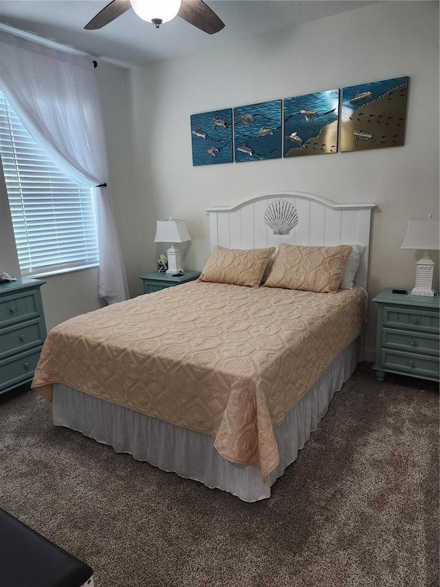 bedroom with ceiling fan and dark carpet