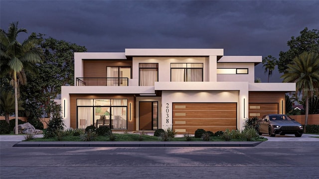 contemporary home featuring a balcony and a garage