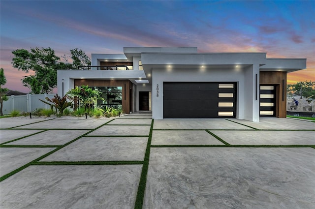 2038 Datura St, Sarasota, FL 34239 - contemporary house with concrete driveway, stucco siding, an attached garage, and fence