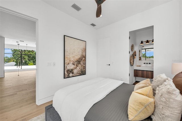 2038 Datura St, Sarasota, FL 34239 - bedroom with multiple windows, visible vents, and light wood-style flooring