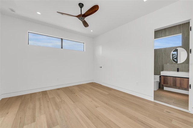 2038 Datura St, Sarasota, FL 34239 - unfurnished bedroom with ceiling fan, ensuite bath, and wood finished floors