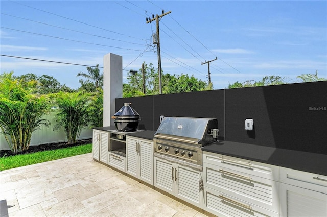2038 Datura St, Sarasota, FL 34239 - view of patio featuring fence, an outdoor kitchen, and grilling area