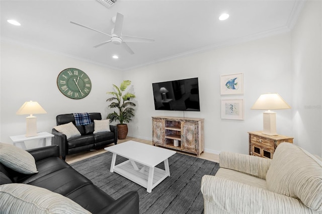 living room featuring hardwood / wood-style floors, ceiling fan, and crown molding