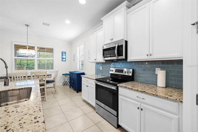 kitchen featuring stainless steel appliances, sink, decorative light fixtures, crown molding, and white cabinets