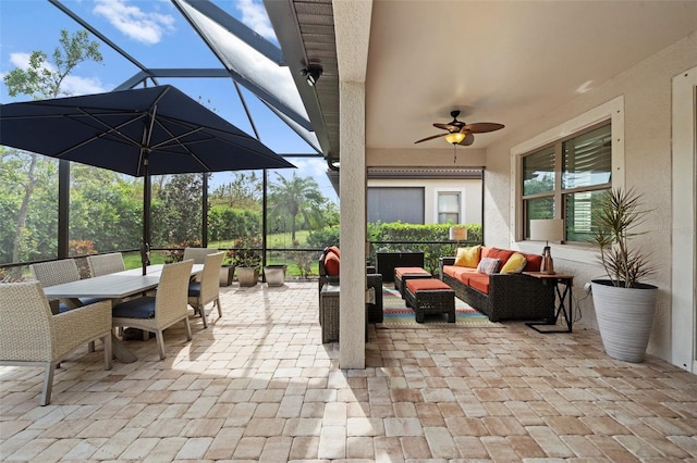 view of patio / terrace featuring ceiling fan, a lanai, and an outdoor living space