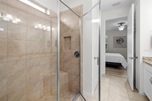 bathroom with ceiling fan, vanity, tile patterned floors, and an enclosed shower