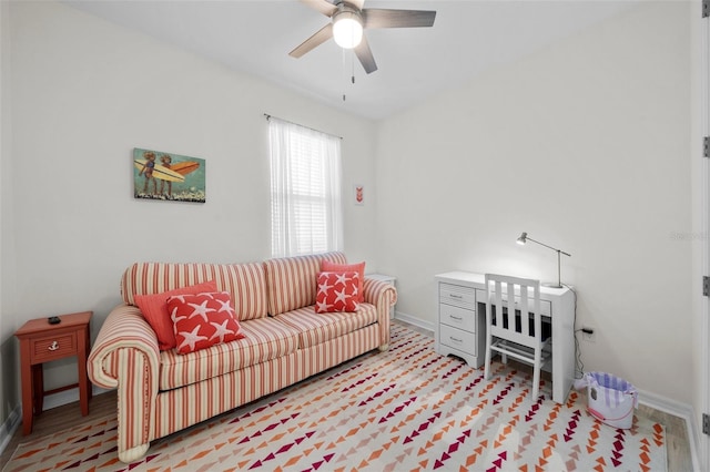 living room featuring light hardwood / wood-style flooring and ceiling fan