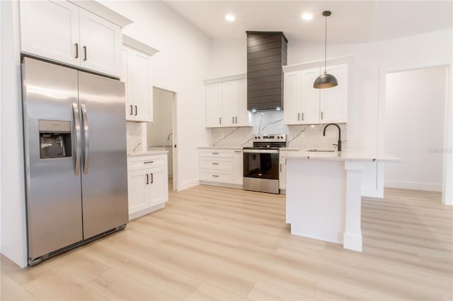 kitchen with stainless steel appliances, hanging light fixtures, and white cabinets