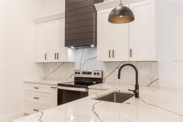 kitchen with light stone counters, sink, and stainless steel range with electric cooktop