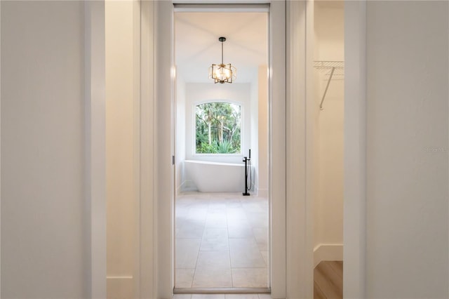 hall with light tile patterned floors