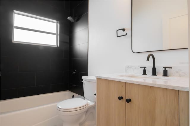 full bathroom with vanity, toilet, and tiled shower / bath combo