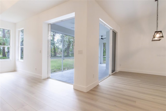 doorway to outside with light wood-type flooring, plenty of natural light, and ceiling fan