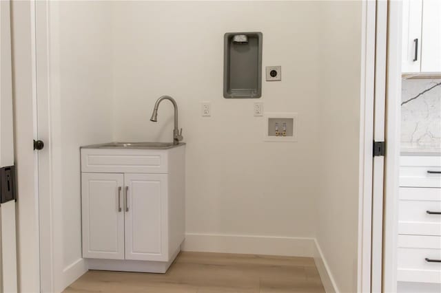 laundry room featuring light wood-type flooring, sink, hookup for a washing machine, and hookup for an electric dryer