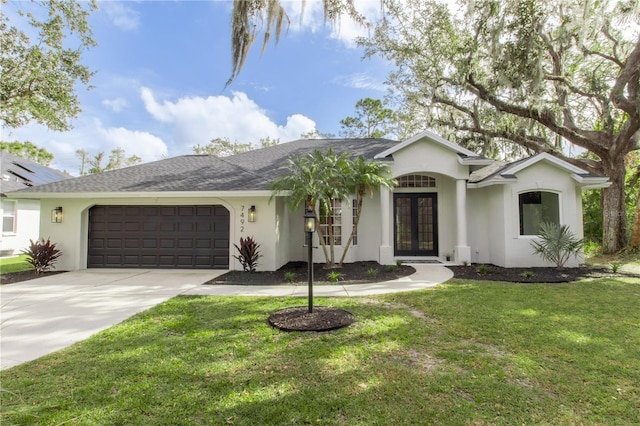 ranch-style house featuring a garage and a front yard