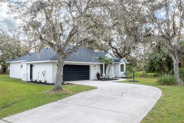 ranch-style house featuring a garage and a front yard