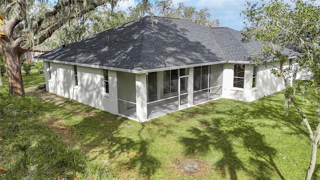 back of house featuring a sunroom and a yard