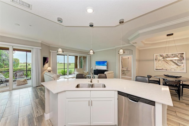 kitchen featuring white cabinets, hanging light fixtures, sink, stainless steel dishwasher, and light hardwood / wood-style flooring