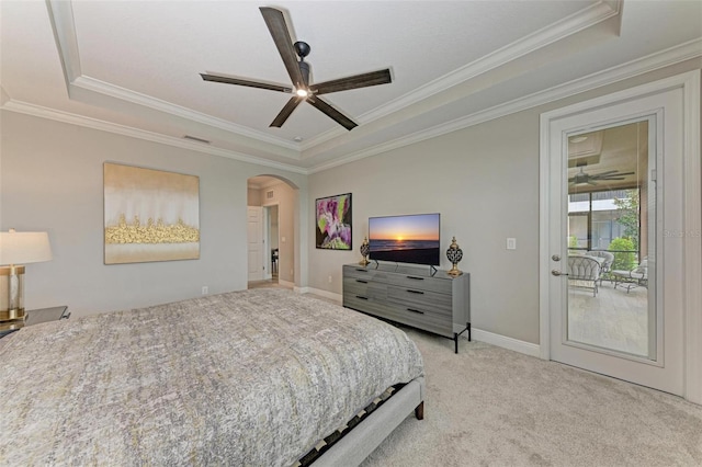 carpeted bedroom featuring access to exterior, ornamental molding, ceiling fan, and a raised ceiling