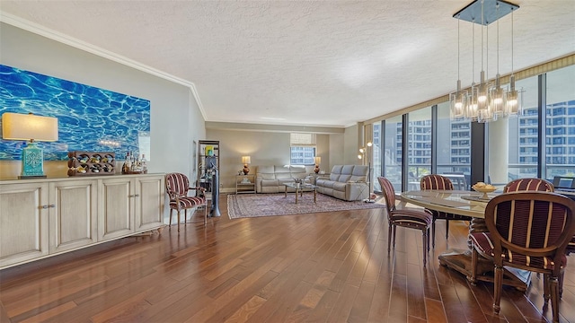 dining room featuring floor to ceiling windows, ornamental molding, a textured ceiling, a chandelier, and dark wood-type flooring