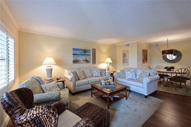 living room featuring wood-type flooring, a textured ceiling, and crown molding