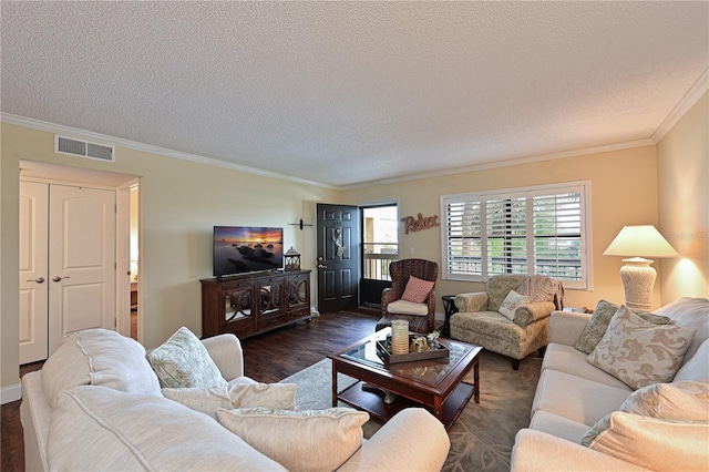 living room featuring dark hardwood / wood-style floors, a textured ceiling, and ornamental molding