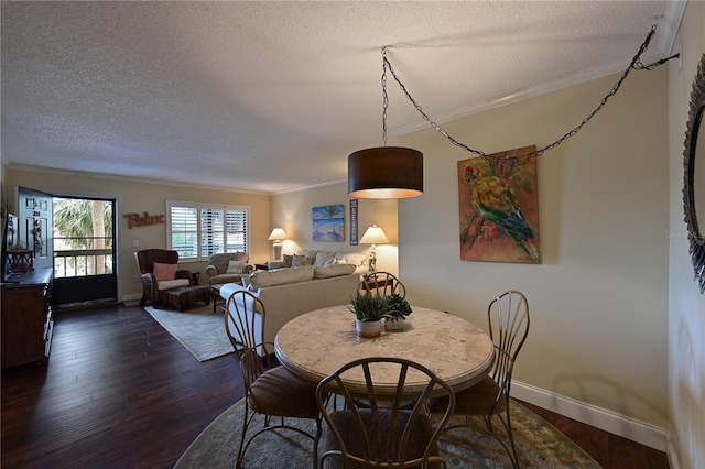 dining area featuring ornamental molding, dark hardwood / wood-style flooring, and a textured ceiling