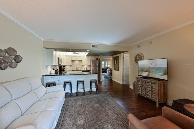 living room with crown molding and dark hardwood / wood-style flooring