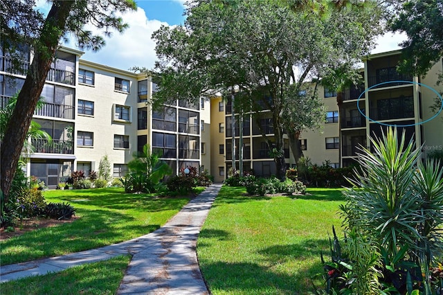 view of property's community with a yard