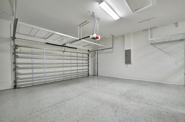 garage featuring electric panel and a garage door opener