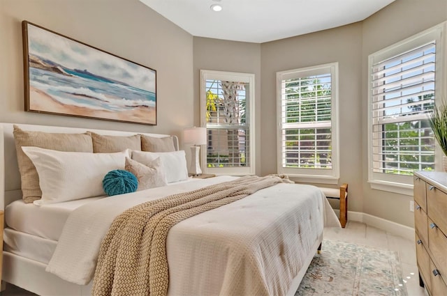 bedroom featuring multiple windows and light tile patterned floors