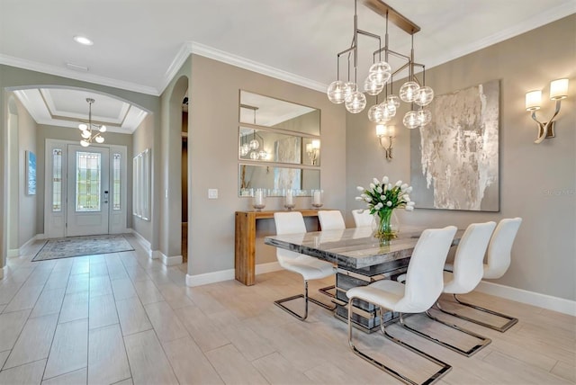 dining room with an inviting chandelier, crown molding, and light hardwood / wood-style flooring