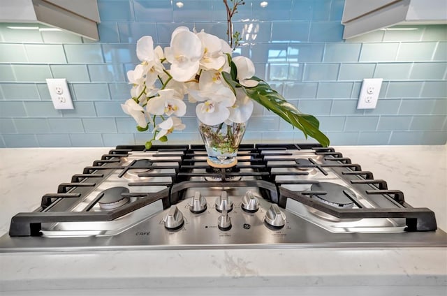 room details featuring decorative backsplash and stainless steel gas stovetop