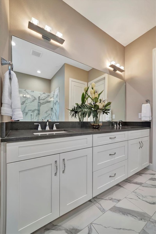 bathroom featuring vanity and a shower with door