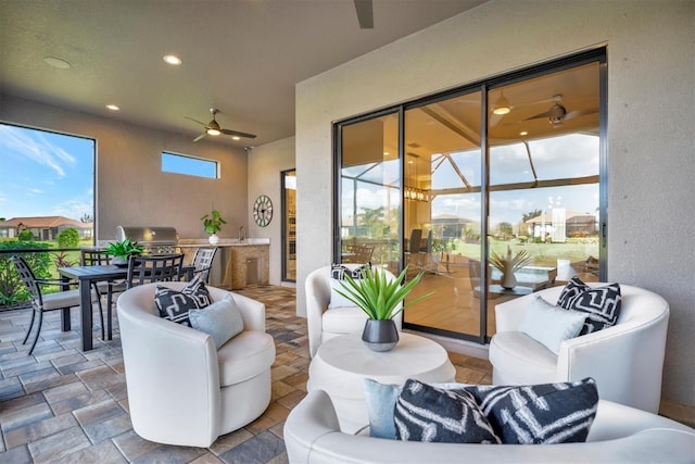 view of patio / terrace featuring area for grilling, ceiling fan, and exterior kitchen