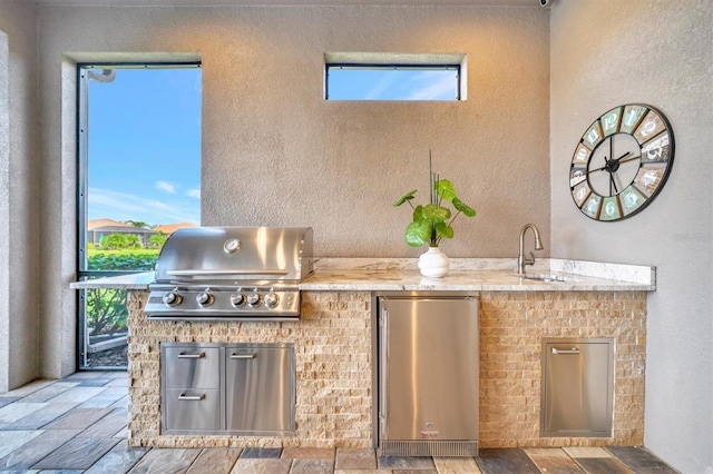 view of patio featuring sink, area for grilling, and exterior kitchen