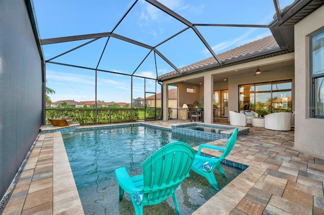 view of swimming pool with glass enclosure, an in ground hot tub, and a patio