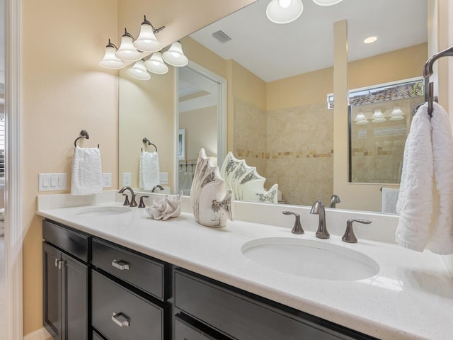 bathroom with vanity and a tile shower