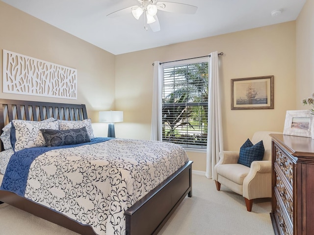 bedroom with ceiling fan and light colored carpet