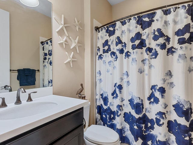 bathroom with toilet and vanity