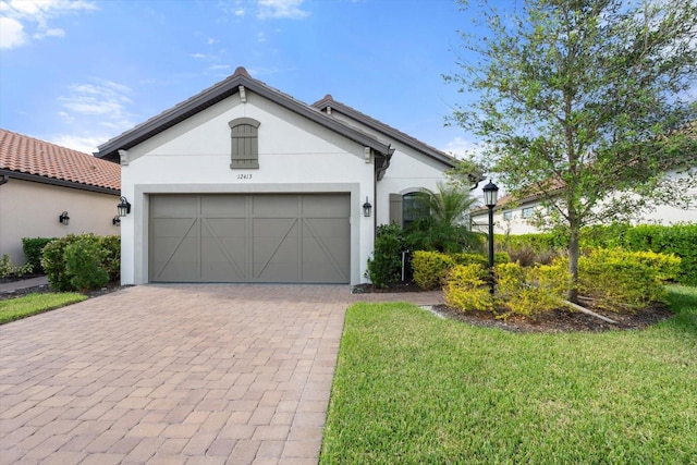 view of front of property with a front lawn and a garage